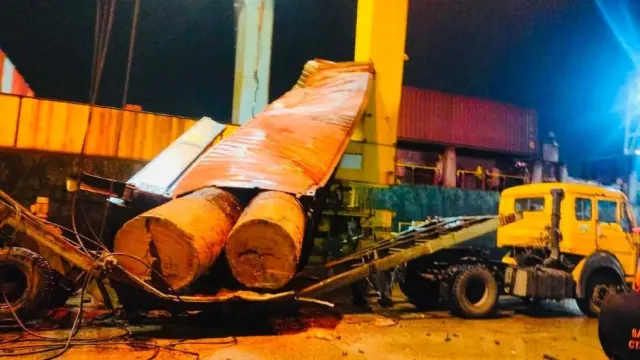 Container carrying heavy logs falls onto trailer at Chattogram port