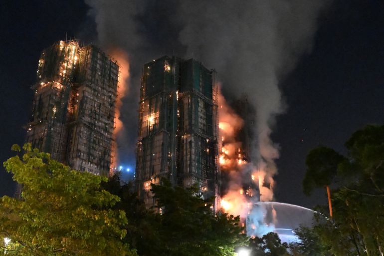 At least 13 dead after fire engulfs residential buildings in Hong Kong