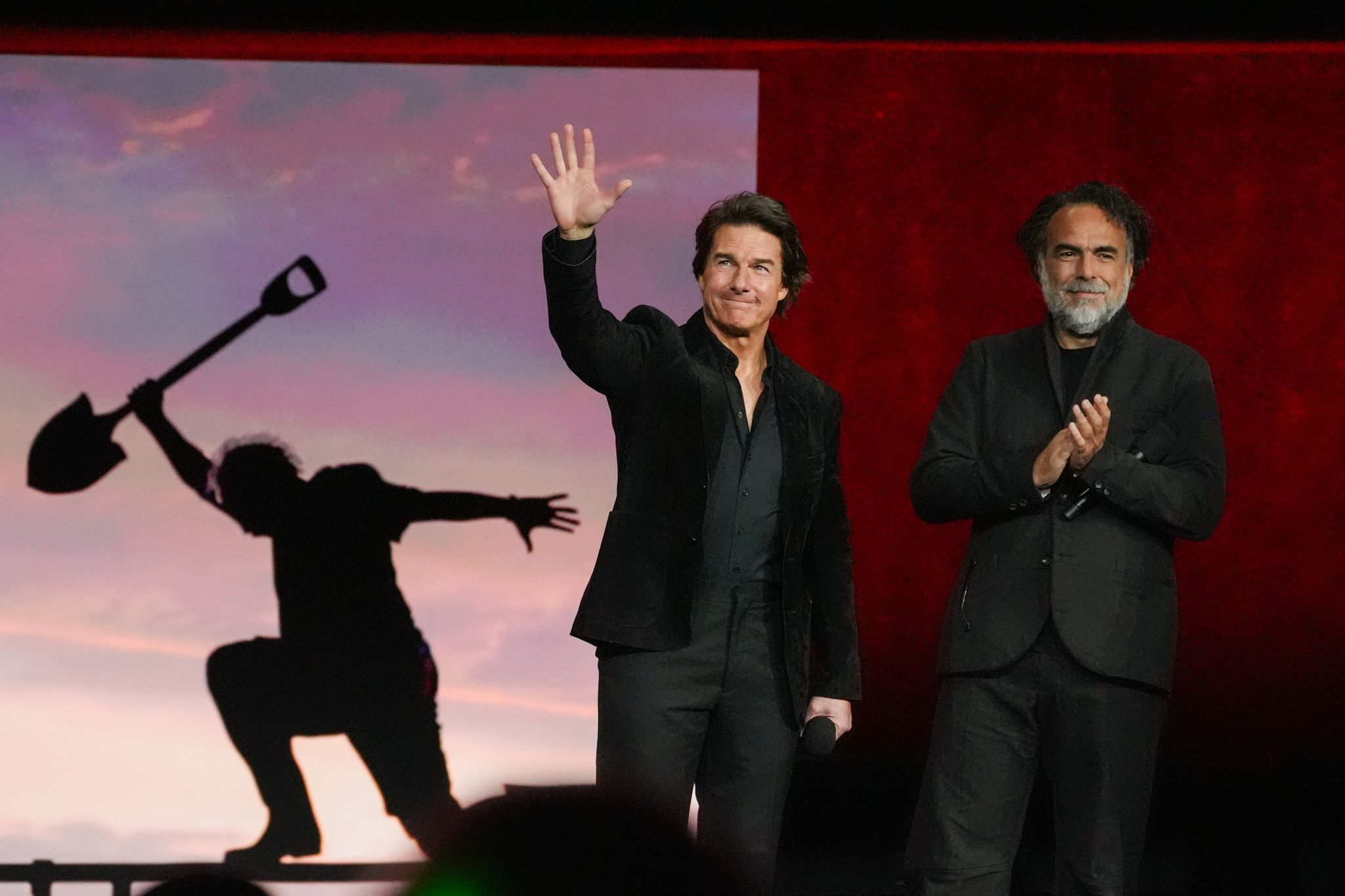 Cruise received a standing ovation from theater owners, marking a rare moment of celebration as he p...