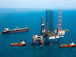 Oil firms evacuate staff, curb offshore production ahead of twin storms