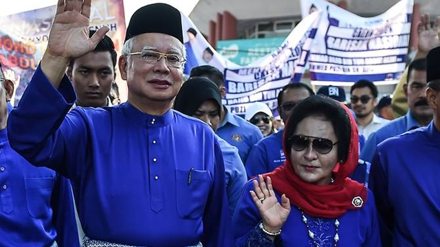 Malaysia bars Najib and wife from leaving country