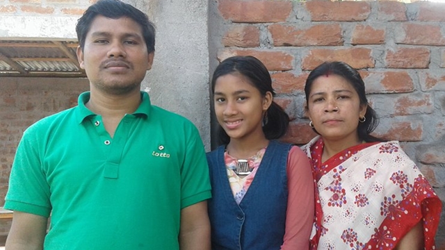 Sristi Barma (middle) with her parents